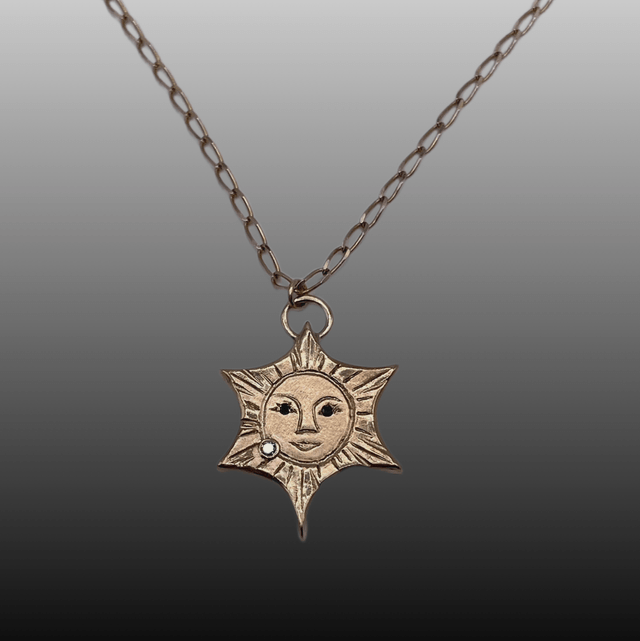 9ct yellow gold Sun with Black & White Diamonds