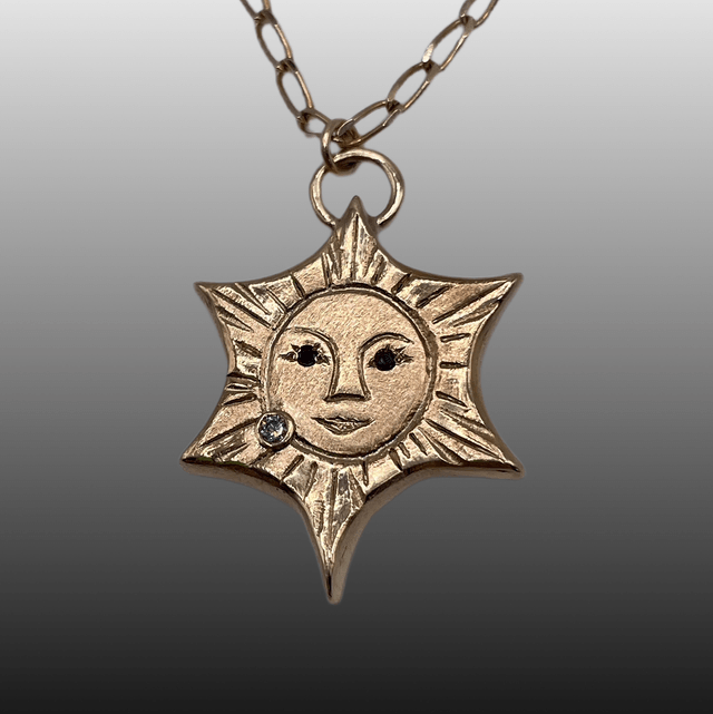 9ct yellow gold Sun with Black & White Diamonds
